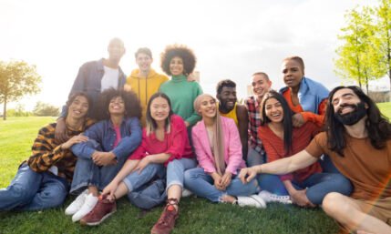 large group of diverse multiracial young people in the park, celebrating life together enjoying happy holidays. lifestyle, travel, togetherness and joy concept